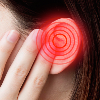 Woman holding hand to infected ear