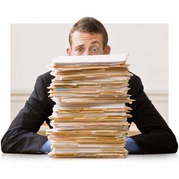 Attorney with shocked expression sitting behind huge pile of paperwork and files