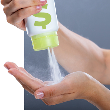 woman pouring talcum powder into her hand from package with dollar sign on it