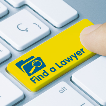 Finger pressing bright yellow keyboard button for 'Find a Lawyer'