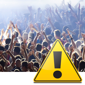 Bright yellow danger sign overlapping photo of crowded concert audience