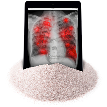 Tablet with lung disease medical scan on screen sitting in a pile of silica dust