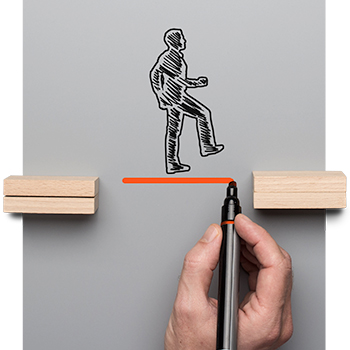 sketch of person walking over wooden blocks; oversized hand drawing in missing block with marker