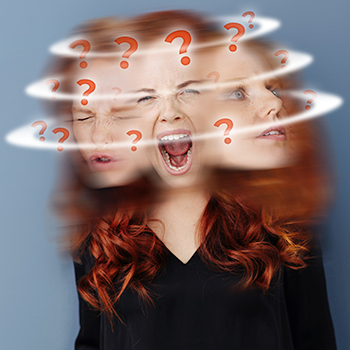 Woman with red hair tossing her head back and forth with orange question marks swirling around her head