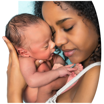 African American woman holding newborn to her face