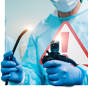 doctor holding colonoscopy equipment with red danger sign on chest