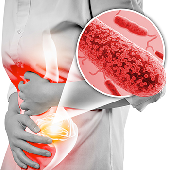 Woman with arms folded over red-highlighted abdomen with enlarged detail of E. Coli bacteria