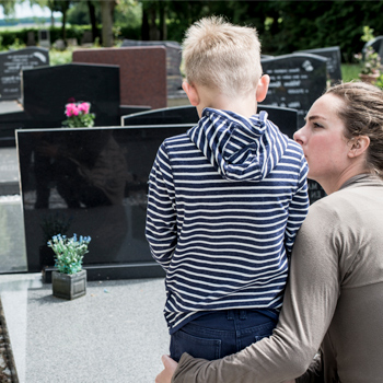 mother and son at father's graveside